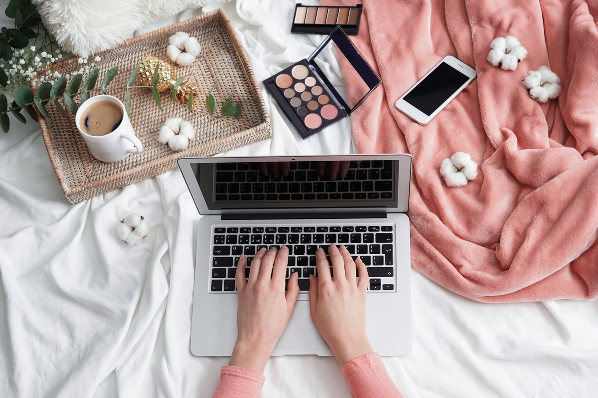 Beauty Blogger Working with Laptop on Bed